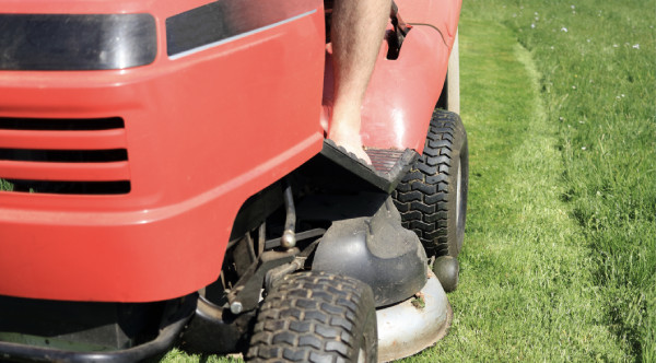 Person riding lawn tractor