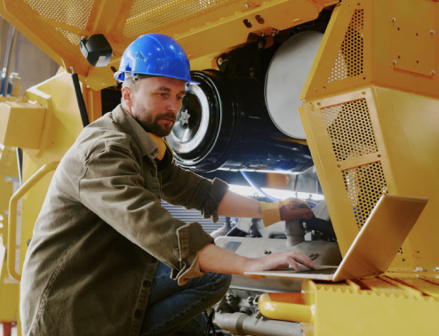 equipment technician working on equipment using STX Garage