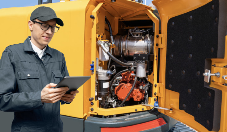 Heavy equipment service technician working on machine