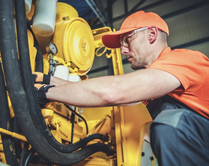equipment technician working on machine