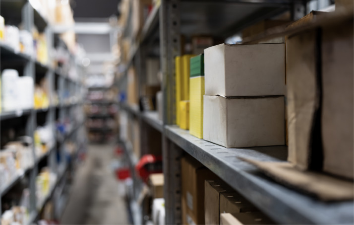 Parts warehouse aisle with stocked shelves and boxes