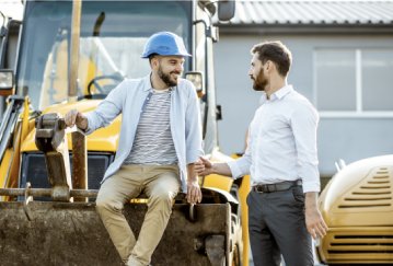 Equipment dealer and owner talking