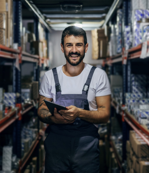 Parts manager in a stockroom checking inventory on a tablet